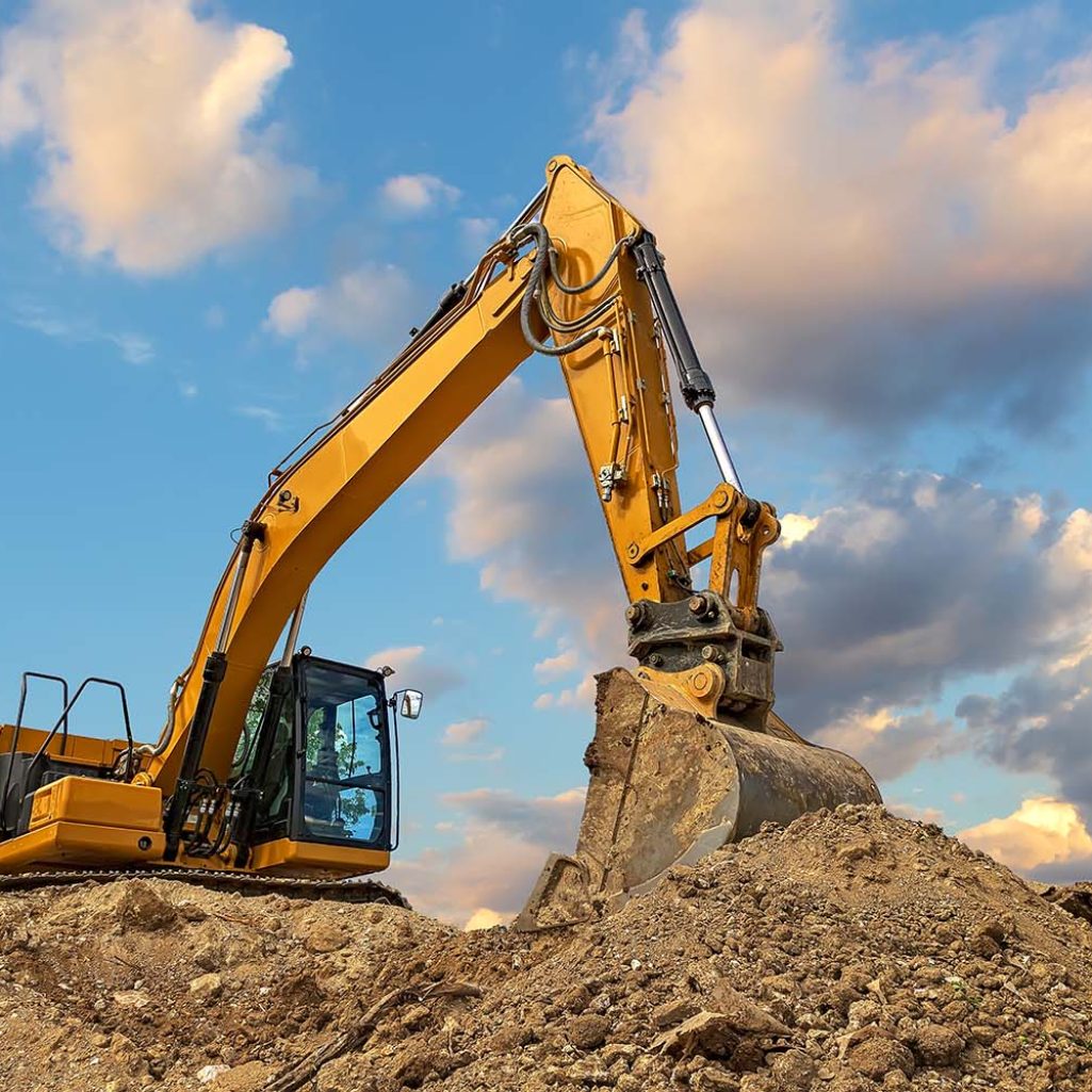 A stopping yellow excavator at stunning fluffy clouds